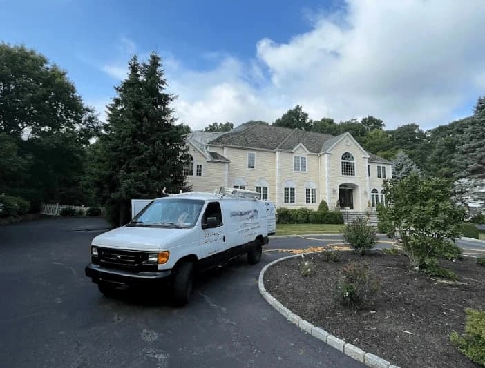 Brunswick Power Washing technician performing thorough gutter cleaning service in Brunswick