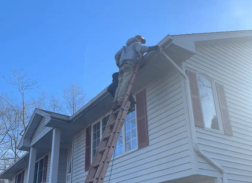 Gutter cleaning and maintenance being performed by Brunswick Power Washing in Brunswick